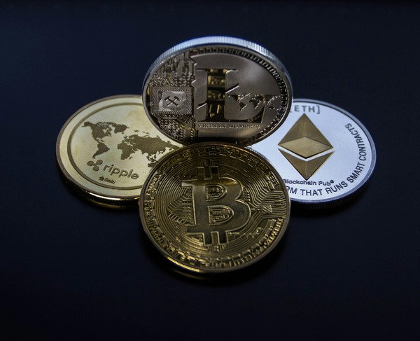 Bitcoin, Ethereum and Ripple coins on a dark background