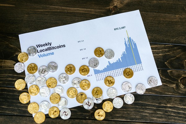 Crypto coins on a printed volume chart