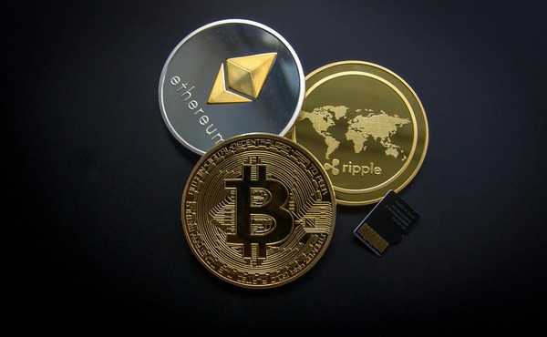 Ethereum, Ripple and Bitcoin coins with a memory card