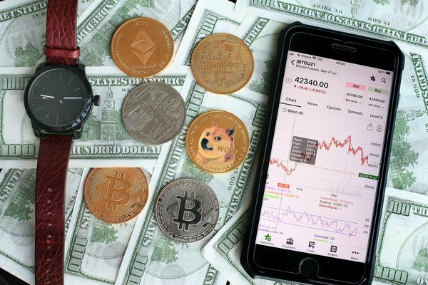 Smartphone with a crypto app, coins and dollar bills