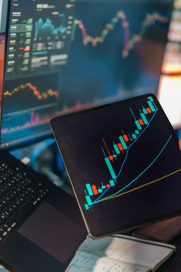 Tablet with a candlestick chart on a desk