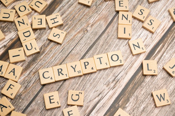 Wooden letter tiles spelling crypto